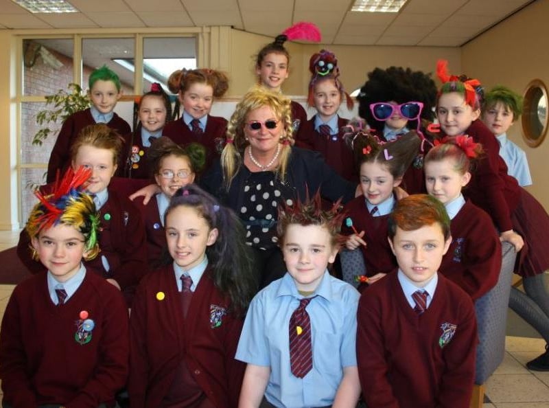 Principal of St. John's PS, Creggan, Geraldine O’Connor, surrounded by the winning KS2 pupils during their Crazy Hair Day fundraiser held last week. Staff, parents and pupils all raised an amazing £1500 from the event. DER4813JM019