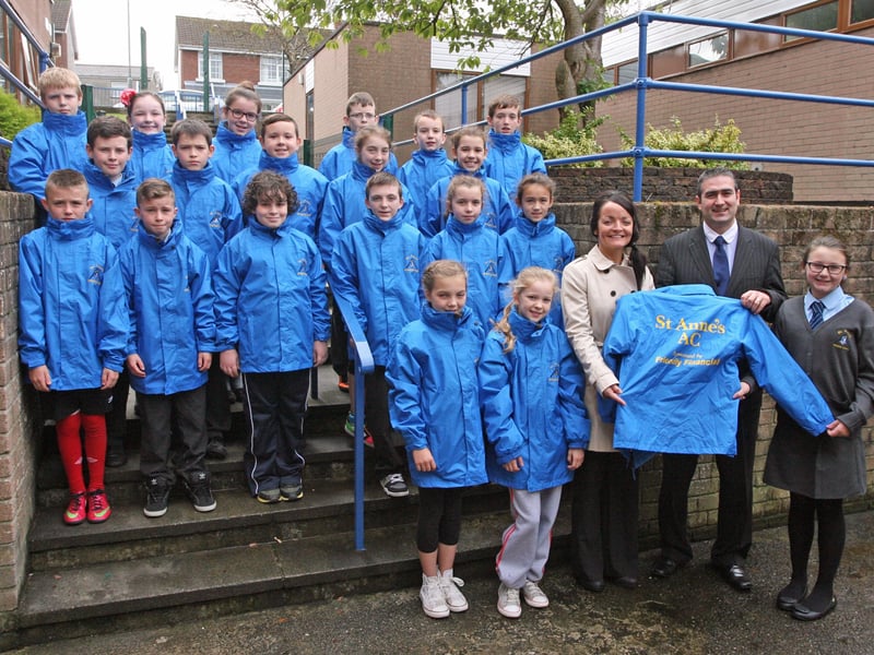 NEW SPORTS JACKETS. . . .Mr. Kristian Hutton, Friendly Financial pictured presenting pupils from St. Anne's PS, Rosemount with new sports jackets for the 2013/14 season at the school on Wednesday morning. Receiving the jackets are Joan McLaughlin, school coach and Aoibh Gallagher, school captain. DER1340JM015