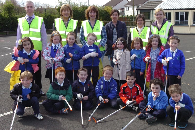 Children from Termoncanice Primary School clean up around the school grounds as part of their green flag preparations. Included, back row from left, are John McCarron, waste management officer, Mary Harron, vice principal, Zita McLaughlin, Linda Kelly Tosh, Sharon Harkin and Una Carton. (0305PG28)