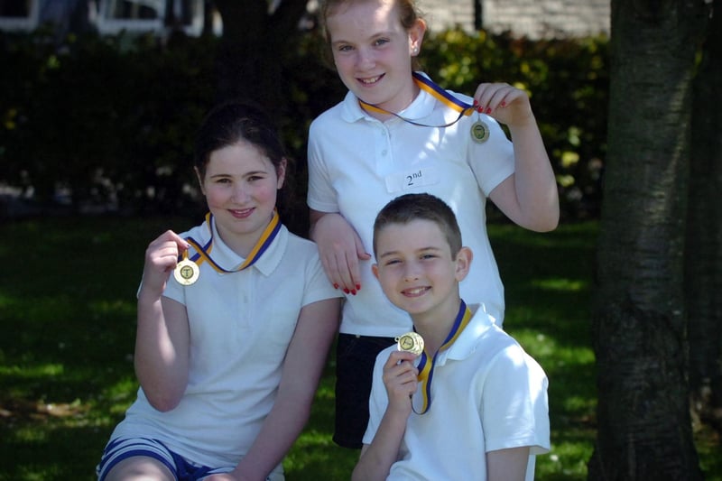 Emma Irwin, left, Charmaine Madden and Eoghan Gormley display the medals they won at the Termoncanice Primary School sports day held on Wednesday. (3105PG71)
