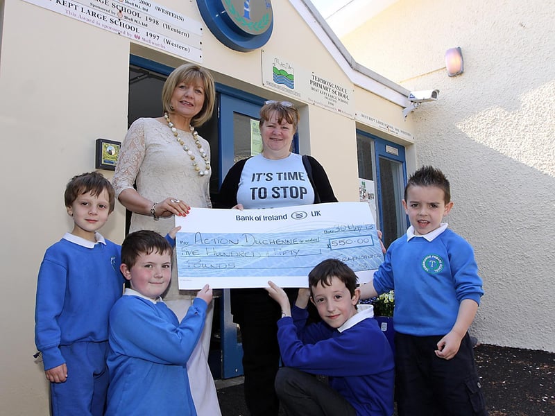 Termoncanice Primary School pupils Matthew Smith, Zac Smith, Callum McCorriston and Kieran O'Loughlin together with school vice principal Mrs Mary Harron pictured handing over a cheque for £550 to Pat Smyth representing Action Duchene. Pupils at the school raised the money at Christmas when they were asked to make donations to the charity rather than buy gifts for their teachers. Included are . 22019KDR