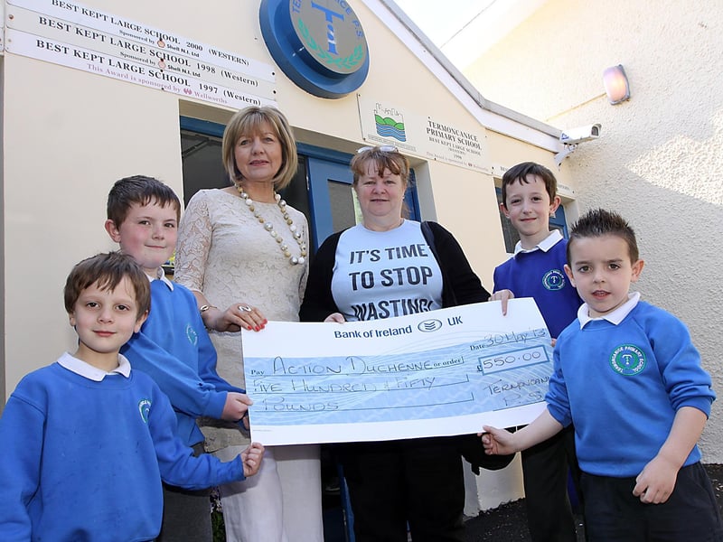 Termoncanice Primary School vice principal Mrs Mary Harron togtehr with a few of the schools and pupils pictured handing over a cheque for £550 to Pat Smyth representing Action Duchene. Pupils at the school raised the money at Christmas when they were asked to make donations to the charity rather than buy gifts for their teachers. Included are Matthew Smith, Zac Smith, Callum McCorriston and Kieran O'Loughlin. INLV2313-018KDR