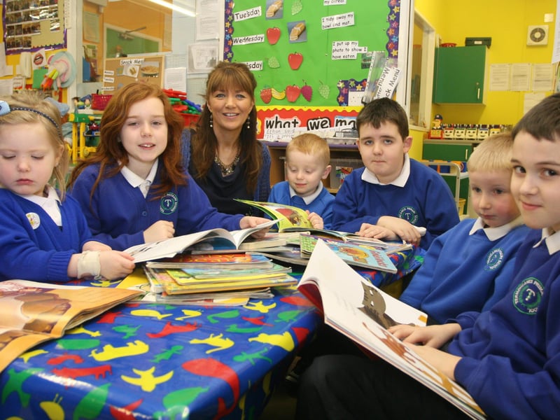 BOOK BUDDIES!. . Ms. Ann Marie Diamond, teacher, Nursery Unit, Termoncanice PS, pictured with some of the nursery pupils and their P6 'buddies' yesterday morning as part of the 'Book Buddies' Day at the Limavady school. The initiative saw pupils from P6 form a partnership with their nursery counterparts in helping them read whilst stimulating the children's imagination and curiosity for future reading skills. 2802JM11