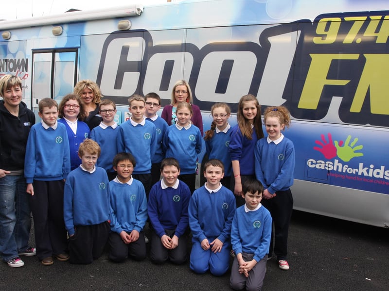 COOL FM BUS. . . Pupils from P7 at Termoncanice PS, Limavady pictured with DJs Sonya Mac and Kellie Smylie, on a visit to the school with the Cool FM BigBus on Tuesday afternoon. Back centre is teacher, Mrs. Sharp. 2803JM15