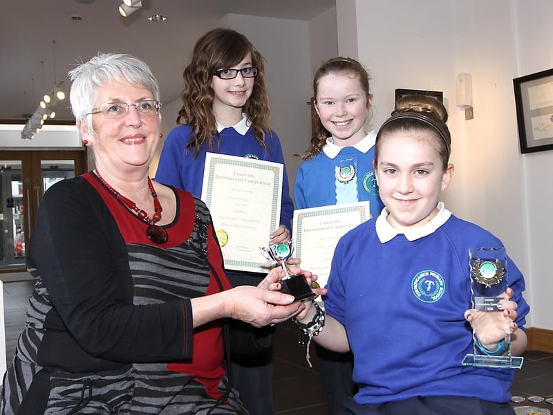 Gabrielle Bonner 1st, Abbi Poland 2nd and Chloe Kelly from Termoncanice Primary School, receive their awards from Mrs Marion Haddon the competition adjudicator for primary schools string section, at the Limavady annual Instrumental competition. INLV0913-081KDR