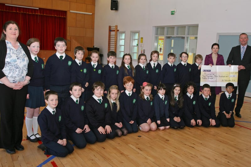 Key Stage 2 Pupils from St. Patrick's PS, Pennyburn pictured handing over a cheque for £2,280 to Ms. Marie Moriarty, Trocaire on Thursday afternoon at the school. Included are Mrs. Karen Crumley (left), Social Awareness Co-Ordinator, and on right, Mr. Eamon Devlin, Principal. 2904JM13