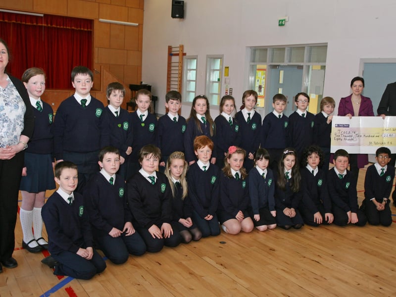 Key Stage 2 Pupils from St. Patrick's PS, Pennyburn pictured handing over a cheque for £2,280 to Ms. Marie Moriarty, Trocaire on Thursday afternoon at the school. Included are Mrs. Karen Crumley (left), Social Awareness Co-Ordinator, and on right, Mr. Eamon Devlin, Principal. 2904JM13