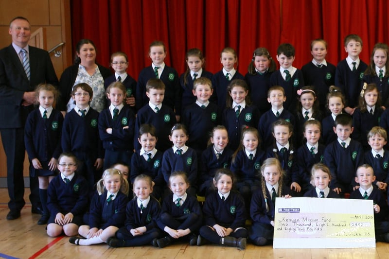Key Stage 1 pupils from St. Patrick's PS, Pennyburn pictured handing over a cheque for "2,882 for the Kenyan Mission Fund during their Lenten Copper Race. Included are Mr. Eamon Devlin, Principal, and Mrs. Karen Crumley, Social Awareness Co-Ordinator (left) and Sister Ann Doherty and Mr. Gerry Deeney, Kenyan Mission Fund (right). 2904JM14