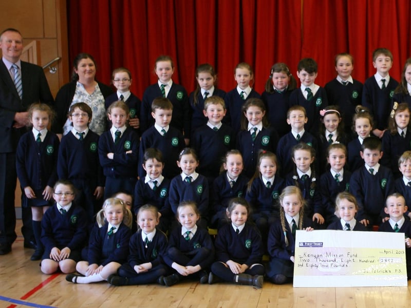 Key Stage 1 pupils from St. Patrick's PS, Pennyburn pictured handing over a cheque for "2,882 for the Kenyan Mission Fund during their Lenten Copper Race. Included are Mr. Eamon Devlin, Principal, and Mrs. Karen Crumley, Social Awareness Co-Ordinator (left) and Sister Ann Doherty and Mr. Gerry Deeney, Kenyan Mission Fund (right). 2904JM14