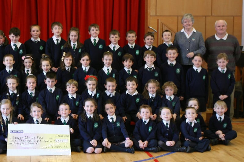 Key Stage 1 pupils from St. Patrick's PS, Pennyburn pictured handing over a cheque for "2,882 for the Kenyan Mission Fund during their Lenten Copper Race. Included are Mr. Eamon Devlin, Principal, and Mrs. Karen Crumley, Social Awareness Co-Ordinator (left) and Sister Ann Doherty and Mr. Gerry Deeney, Kenyan Mission Fund (right). 2904JM14