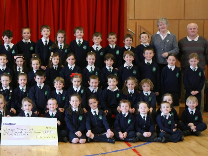 Key Stage 1 pupils from St. Patrick's PS, Pennyburn pictured handing over a cheque for "2,882 for the Kenyan Mission Fund during their Lenten Copper Race. Included are Mr. Eamon Devlin, Principal, and Mrs. Karen Crumley, Social Awareness Co-Ordinator (left) and Sister Ann Doherty and Mr. Gerry Deeney, Kenyan Mission Fund (right). 2904JM14