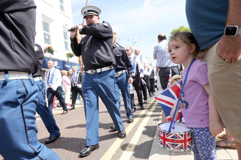 Maisie Adams beats her drum as the bands march past during the Twelfth parade in Larne.
 Picture: Stephen Davison / Pacemaker.
