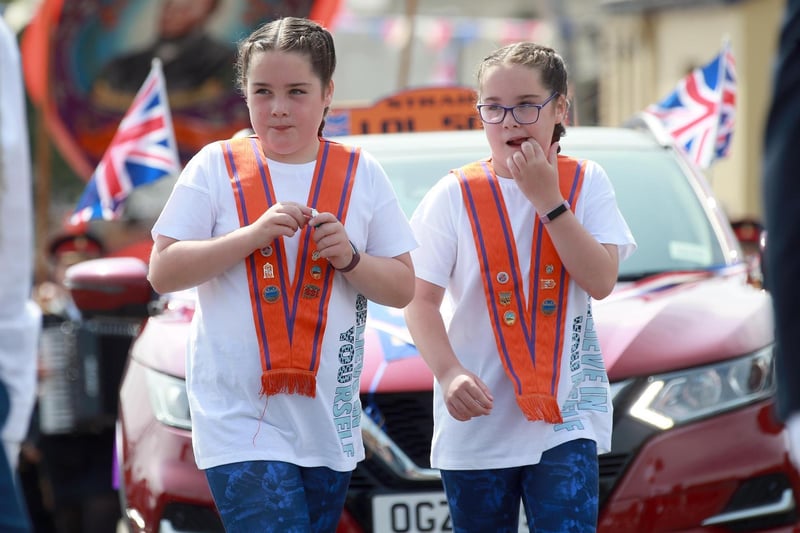 Two young ladies enjoy the walk in the sunshine during the Twelfth demonstration in Larne.