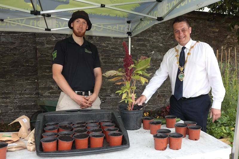 Mayor Graham Warke is holding an "Elephant Amaranth" plant grown by conservation volunteer David Montgomery at the NW Migrants Forum Family Fun Day in Brooke Park. (Photo - Tom Heaney, nwpresspics)