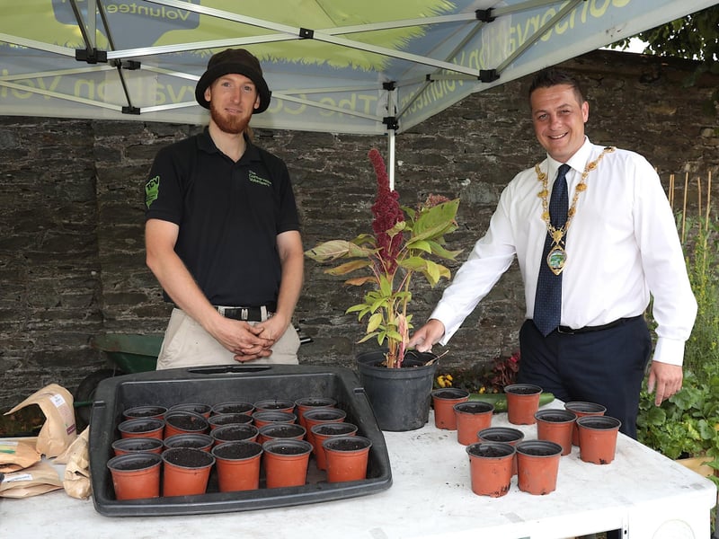 Mayor Graham Warke is holding an "Elephant Amaranth" plant grown by conservation volunteer David Montgomery at the NW Migrants Forum Family Fun Day in Brooke Park. (Photo - Tom Heaney, nwpresspics)
