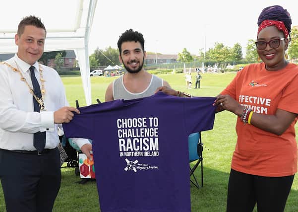Lilian Seenoi-Barr, director, NWMF,  and Yusuf presents a T-shirt to Mayor Graham Warke at the NW Migrants Forum Family Fun Day in Brooke Park. (Photo - Tom Heaney, nwpresspics)