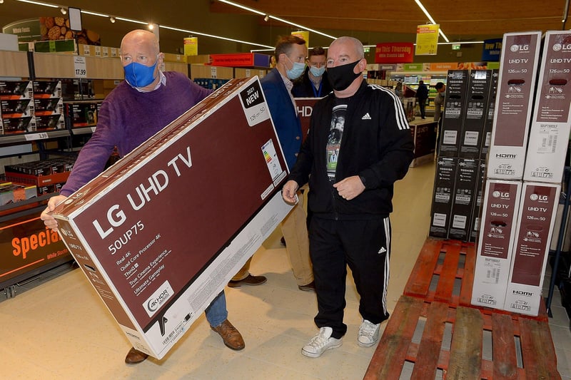 Customers pick up televisions at a bargain price at the opening of the new£8m Lidl superstore in Springtown on Thursday morning. Photos: George Sweeney. DER2130GS - 027
