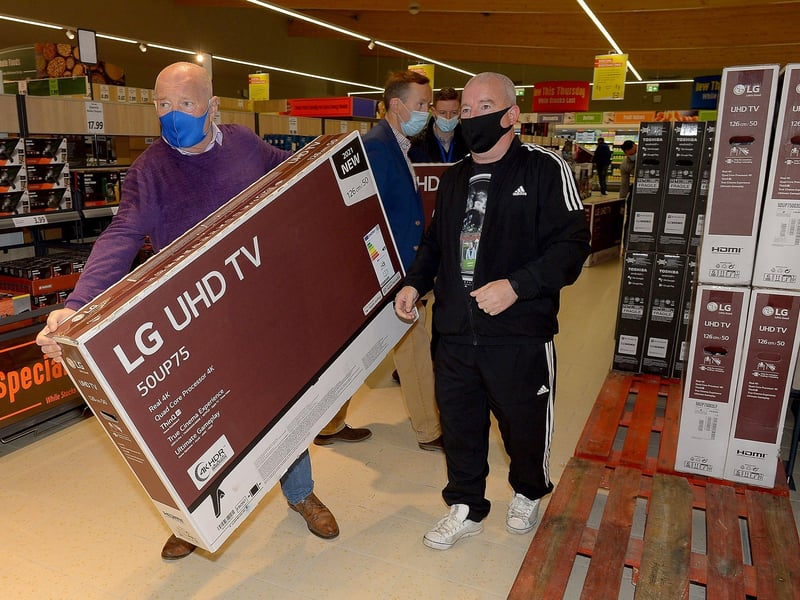Customers pick up televisions at a bargain price at the opening of the new£8m Lidl superstore in Springtown on Thursday morning. Photos: George Sweeney. DER2130GS - 027