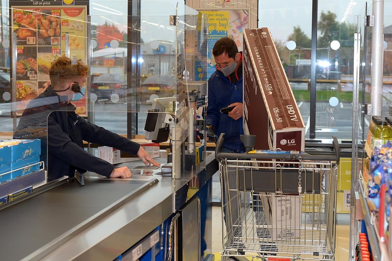Customer buying a bargain priced television at the opening of the new£8m Lidl superstore in Springtown on Thursday morning. DER2130GS - 030