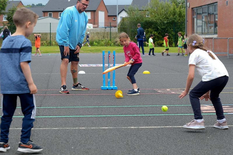 Boys and girls enjoy cricket, with Gary McDaid from Eglinton Cricket Club, at the recent sports camp at Broadbridge Primary School. DER2130GS - 051 (Picture by George Sweeney)