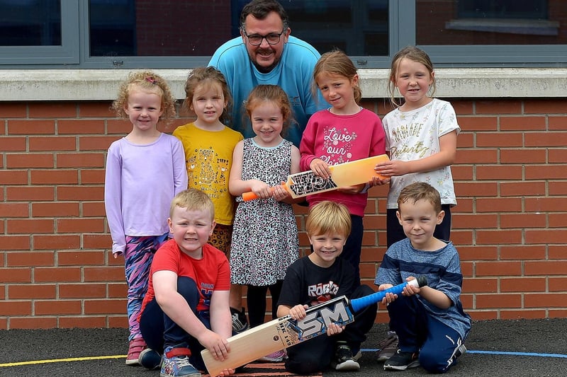 Gary McDaid from Eglinton Cricket Club pictured with kids who took part in the recent sports camp at Broadbridge Primary School. DER2130GS - 053 (Picture by George Sweeney)
