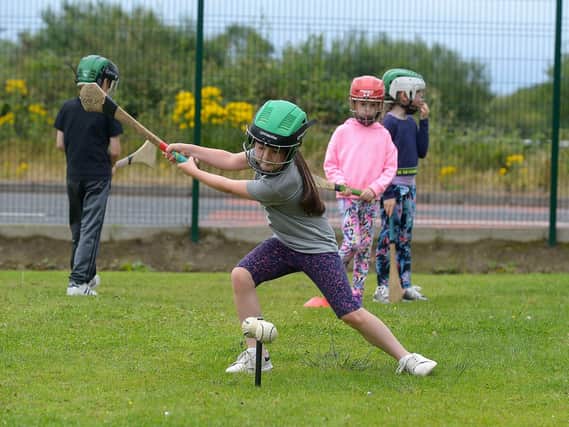 Young girl developing her hurling skill at the recent sports camp at Broadbridge Primary School. DER2130GS - 048 (Picture by George Sweeney)