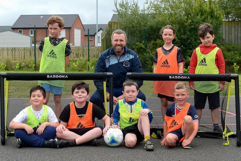 Gary Forth, Youth Development Manager at Institute, with some of the children who took part in the recent sports camp at Broadbridge Primary School. DER2130GS - 056 (Picture by George Sweeney)