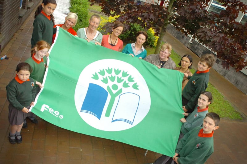 Staff and children from Greenhaw Primary School eco team celebrate receiving the Green Flag Award for developing into an eco friendly school. Included, from left, Eimear McWilliams, Emily O'Brien, Aisling Chada, Deidre O'Connoll, Daisy Mules, eco co-ordinator, Arlene Bowe, Roberta Wilson, Mirium Ward, parent governor, Vindi Torney, principal, Oran Campbell, Suzi Coyle and Aaron Gallick. (2706PG27)
