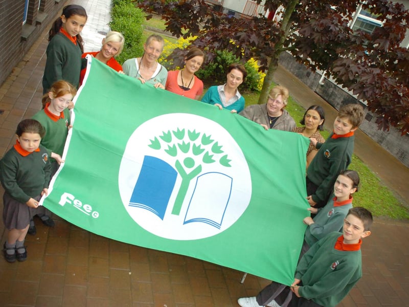 Staff and children from Greenhaw Primary School eco team celebrate receiving the Green Flag Award for developing into an eco friendly school. Included, from left, Eimear McWilliams, Emily O'Brien, Aisling Chada, Deidre O'Connoll, Daisy Mules, eco co-ordinator, Arlene Bowe, Roberta Wilson, Mirium Ward, parent governor, Vindi Torney, principal, Oran Campbell, Suzi Coyle and Aaron Gallick. (2706PG27)