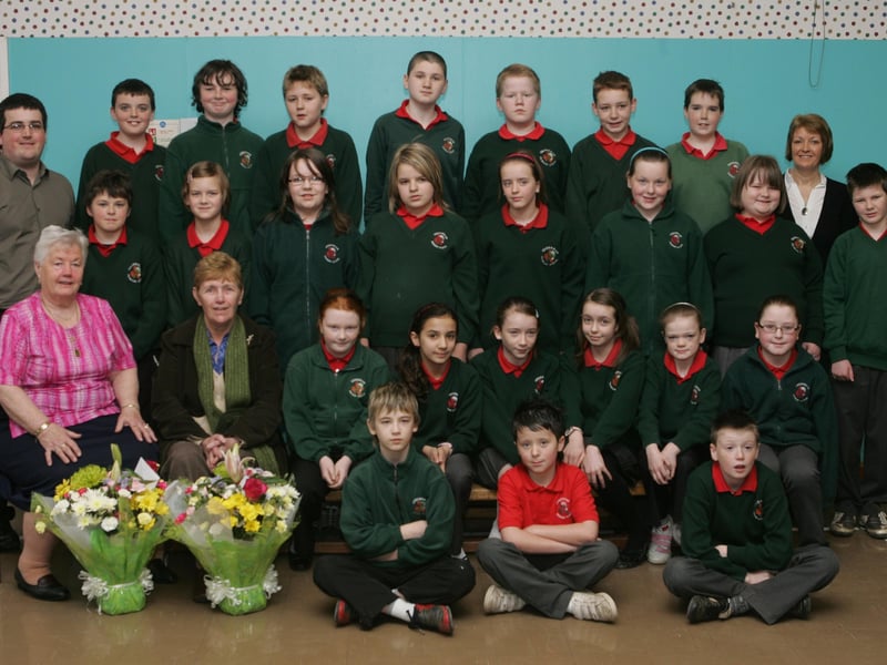 P7 pupils from Greenhaw Primary School who presenting bouquets of flowers to Rita McLaughlin and Ita McBride, from the Northside 50+ Club, on completion of the storytelling series organised as part of the Housing Executive Junior Warden Scheme. Included are Mr. Patrick Duddy, social education officer, NIHE, and Ms. Ruth McKay, teacher. (0404C05)