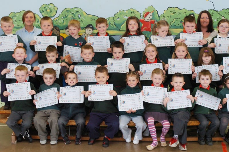 P2 pupils from Greenhaw Primary School receive certificates for completing a paired maths programme. Included is classroom assistant Roisin McCafferty, and class teacher Helen McGrelis. (0505PG15)