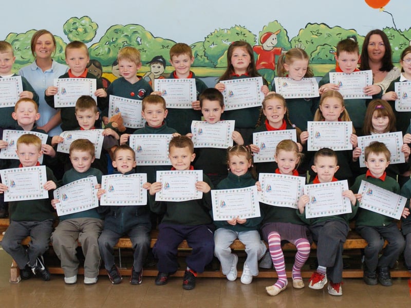 P2 pupils from Greenhaw Primary School receive certificates for completing a paired maths programme. Included is classroom assistant Roisin McCafferty, and class teacher Helen McGrelis. (0505PG15)