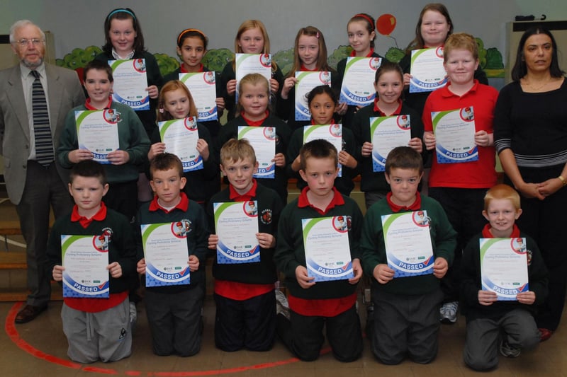 Ian Doherty, DOE Senior Road Safety Education Officer, pictured with Primary 6 and 7 pupils at Greenhaw Primary School who have achieved Road Safety Cycling Proficiency Scheme certificates. Included is Vindi Torney, Principal. LS43-113KM