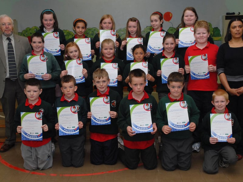 Ian Doherty, DOE Senior Road Safety Education Officer, pictured with Primary 6 and 7 pupils at Greenhaw Primary School who have achieved Road Safety Cycling Proficiency Scheme certificates. Included is Vindi Torney, Principal. LS43-113KM