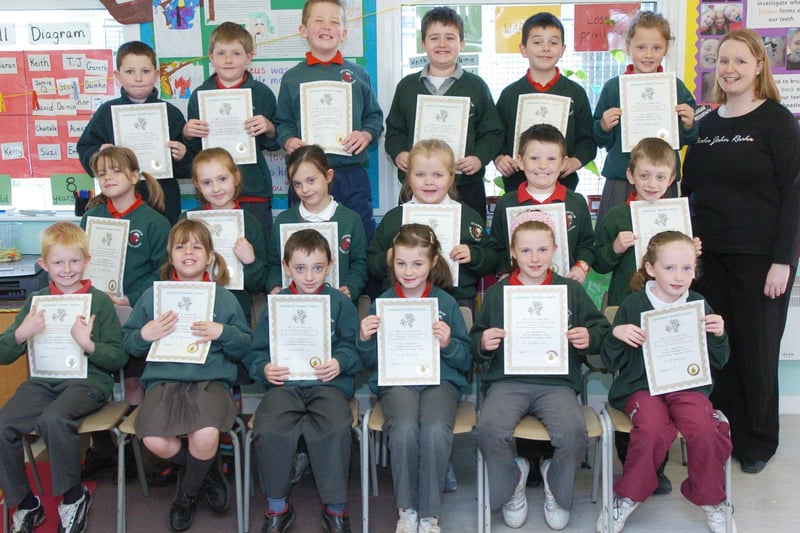 P4 pupils from Greenhaw Primary School receive certificates for completing a paired reading programme. Included is class teacher Sinead McFadden. (0505PG11)