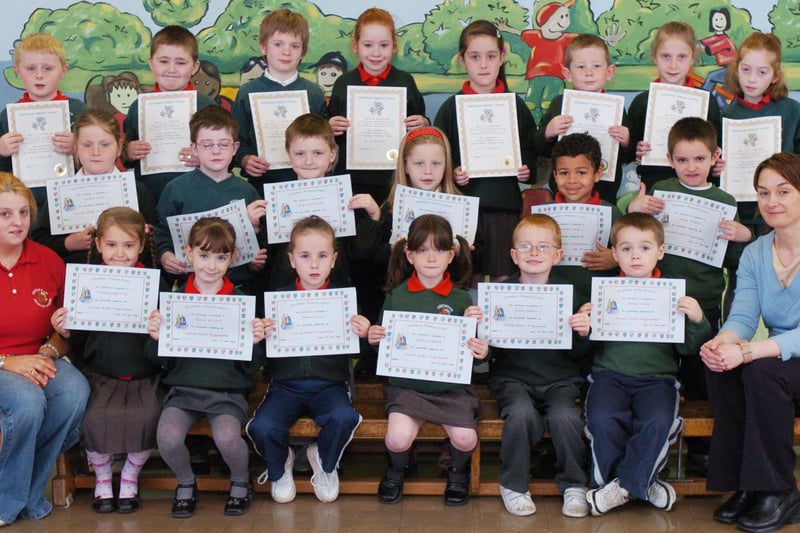 P3 and P2 pupils from Greenhaw Primary School receive certificates for completing paired reading and paired maths programmes. Included is classroom assistant Shauna McCay, left, and class teacher Roberta Wilson. (0505PG14)