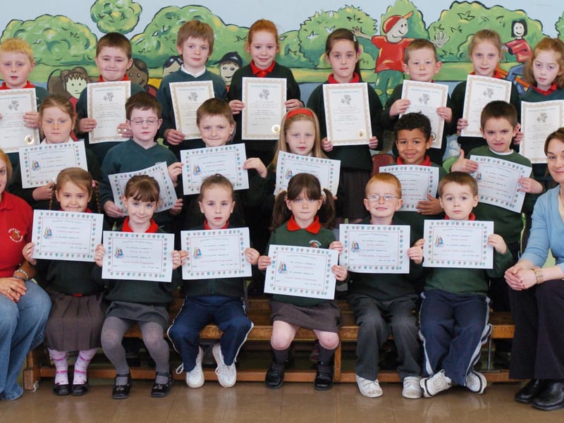 P3 and P2 pupils from Greenhaw Primary School receive certificates for completing paired reading and paired maths programmes. Included is classroom assistant Shauna McCay, left, and class teacher Roberta Wilson. (0505PG14)