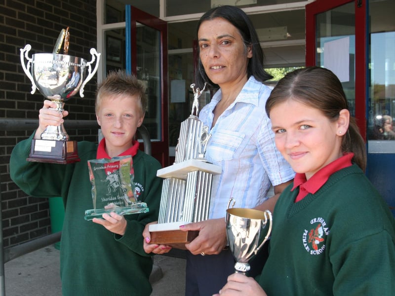 Vindi Torney, principal, Greenhaw Primary School, with pupils who collected awards at the school's annual prize-giving. Connor Harkin, received the trophies for 'Player of the Year', in football and athletics, and a cup for Sporting Achievement and Megan McKeever, received the female 'Sports Person of the Year' award. (2806T01).