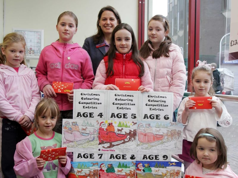 Carolann Smyth, HR manager, Supervalu, Waterloo Place, with prizewinners in the Christmas Colouring Competition. From left are Aine Courtney (Oakgrove PS), Ciona McCauley (St. John's PS) Hayley McGowan (Nazareth House), Suzie Coyle (Greenhaw PS), Katie Taggart (St. Eugene's PS), Ciara Doherty (St. Anne's PS) and Niamh Ward (Glendermott PS). (0201C15)