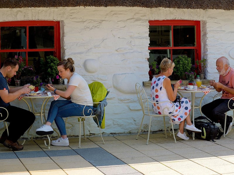 People have a coffee in the Craft Village yesterday afternoon’s sunny spell. DER2134GS – 035