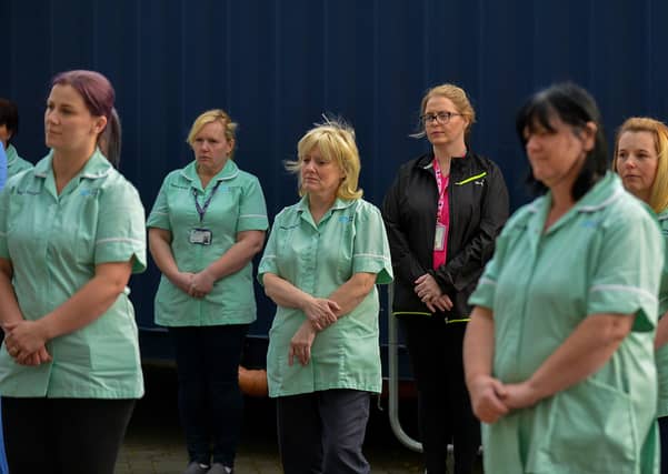 Care staff from Altnagelvin hospital, pictured on Thursday evening last, during an Act of Remembrance for all who have lost their battle with COVID-19. DER2020GS – 023