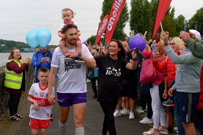 Danny Quigley’s partner Emear and sons Jack and Malachi accompany his on his arrival at Destined after completing a gruelling 10 Ironman Triathlons in 10 days in memory of his dad and fundraising over £68,000 for charities.  Photo: George Sweeney / Derry Journal.  DER2135GS – 020