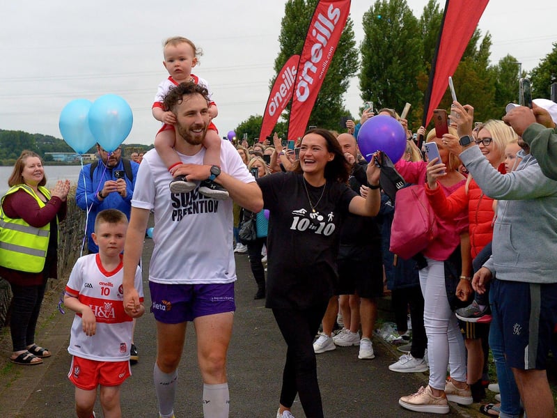 Danny Quigley’s partner Emear and sons Jack and Malachi accompany his on his arrival at Destined after completing a gruelling 10 Ironman Triathlons in 10 days in memory of his dad and fundraising over £68,000 for charities.  Photo: George Sweeney / Derry Journal.  DER2135GS – 020