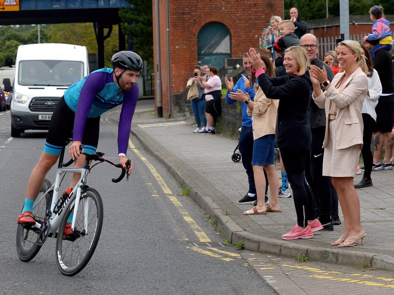 Ironman triathlon hero Danny Quigley is greeted by supporters and well-wishers as he arrives at Destine’s premises, Foyle Road, on Sunday afternoon after completing his tenth and final daily 112 mile cycle before setting off on his final 26.2 miles run to complete 10 triathlons in 10 days. Photo: George Sweeney / Derry Journal. DER2135GS – 002