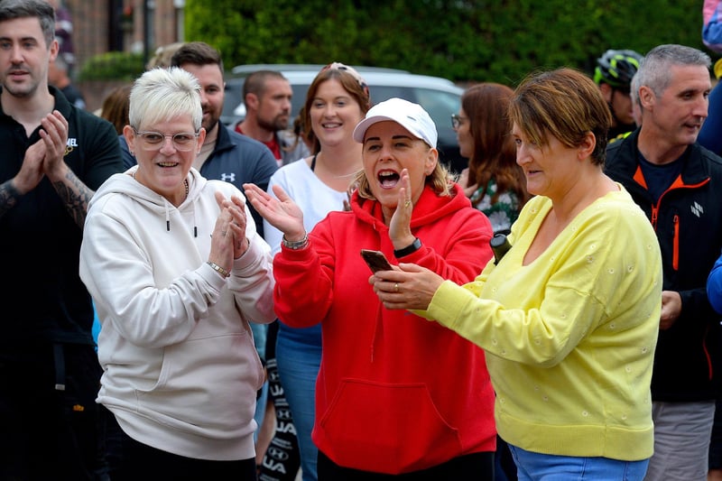 Supporters greet epic triathlon hero Danny Quigley as he arrives at Destine’s premises, Foyle Road, on Sunday afternoon after completing his tenth and final daily 112 mile cycle before setting off on his final 26.2 miles run to complete 10 triathlons in 10 days for charity. Photo: George Sweeney / Derry Journal.  DER2135GS – 008