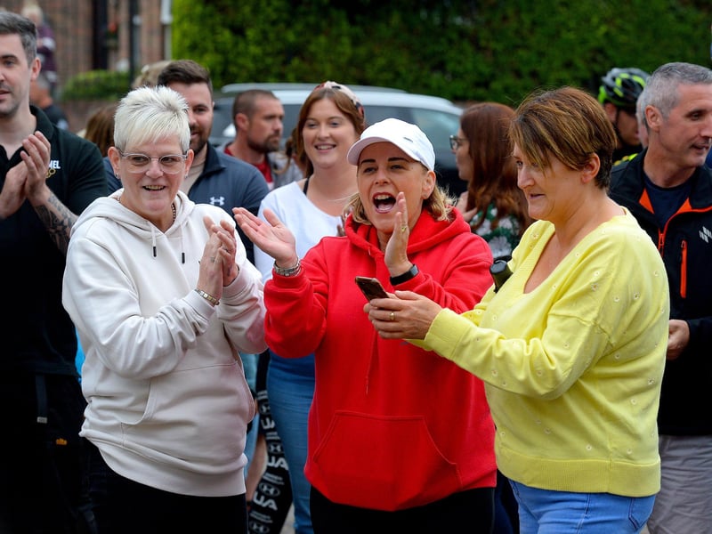 Supporters greet epic triathlon hero Danny Quigley as he arrives at Destine’s premises, Foyle Road, on Sunday afternoon after completing his tenth and final daily 112 mile cycle before setting off on his final 26.2 miles run to complete 10 triathlons in 10 days for charity. Photo: George Sweeney / Derry Journal. DER2135GS – 008