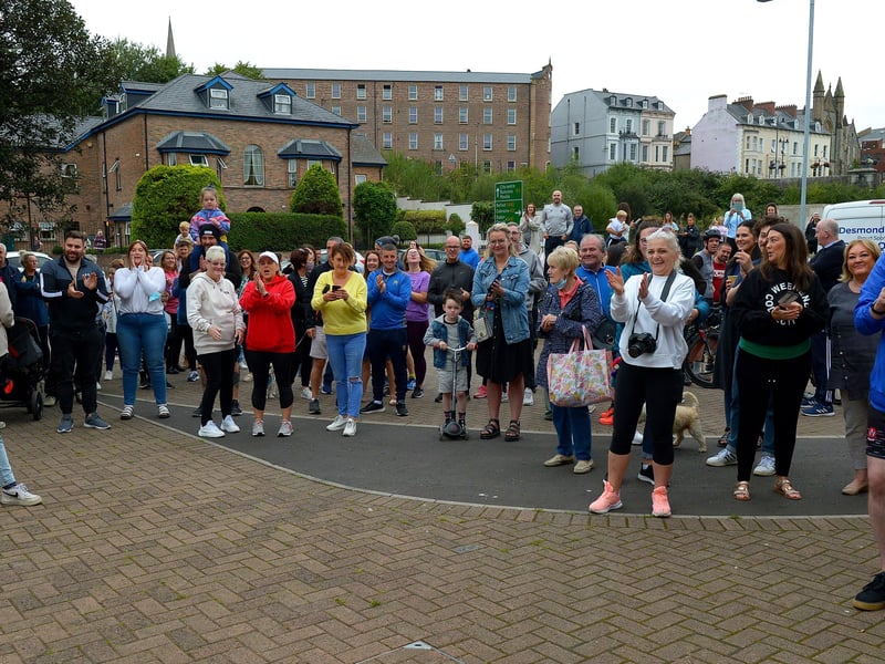 Supporters and well-wishers greet epic triathlon hero Danny Quigley as he arrives at Destine’s premises, Foyle Road, on Sunday afternoon after completing his tenth and final daily 112 mile cycle before setting off on his final 26.2 miles run to complete 10 triathlons in 10 days for charity. Photo: George Sweeney / Derry Journal. DER2135GS – 009