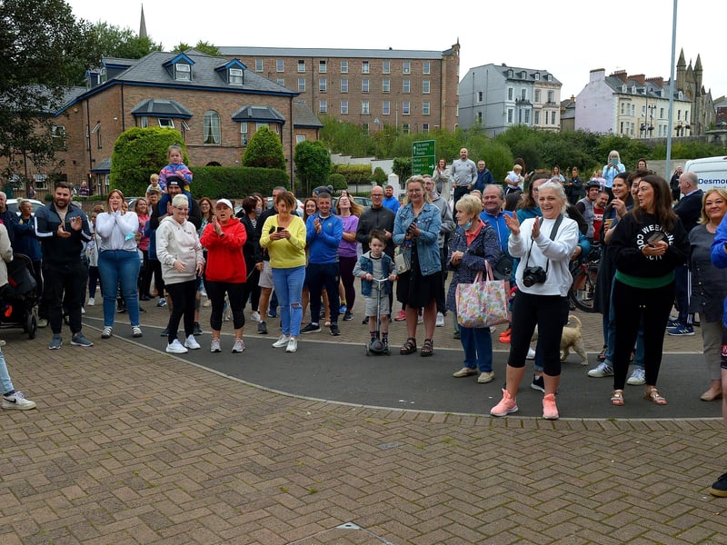 Supporters and well-wishers greet epic triathlon hero Danny Quigley as he arrives at Destine’s premises, Foyle Road, on Sunday afternoon after completing his tenth and final daily 112 mile cycle before setting off on his final 26.2 miles run to complete 10 triathlons in 10 days for charity. Photo: George Sweeney / Derry Journal.  DER2135GS – 009