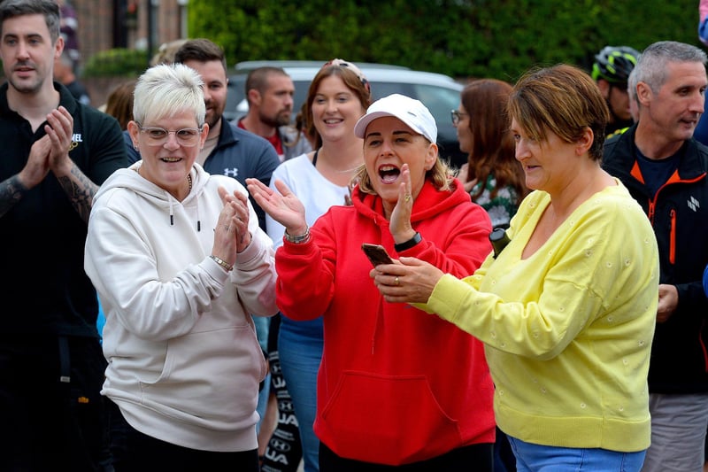 Supporters greet epic triathlon hero Danny Quigley as he arrives at Destine’s premises, Foyle Road, on Sunday afternoon after completing his tenth and final daily 112 mile cycle before setting off on his final 26.2 miles run to complete 10 triathlons in 10 days for charity. Photo: George Sweeney / Derry Journal.  DER2135GS – 008