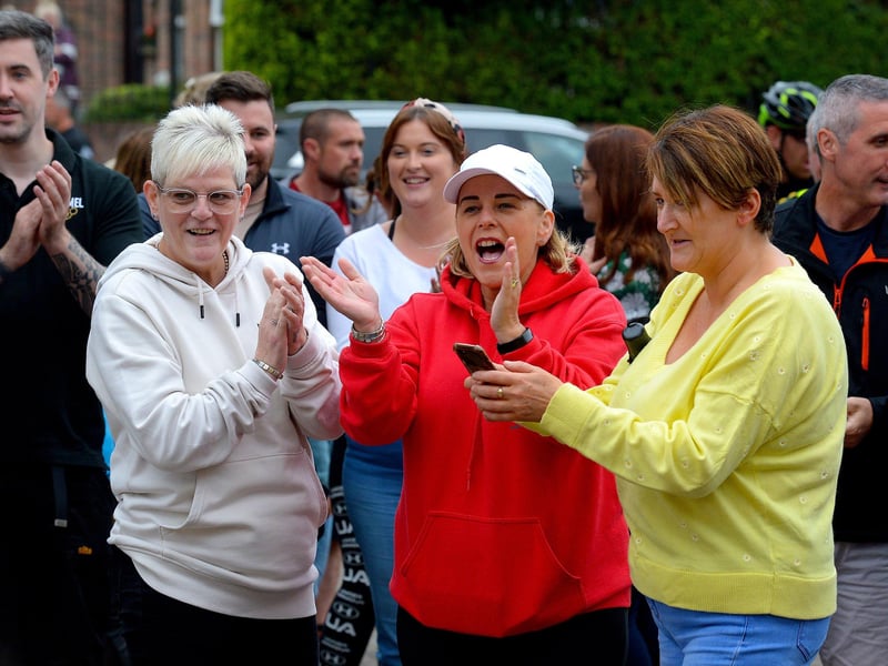 Supporters greet epic triathlon hero Danny Quigley as he arrives at Destine’s premises, Foyle Road, on Sunday afternoon after completing his tenth and final daily 112 mile cycle before setting off on his final 26.2 miles run to complete 10 triathlons in 10 days for charity. Photo: George Sweeney / Derry Journal. DER2135GS – 008